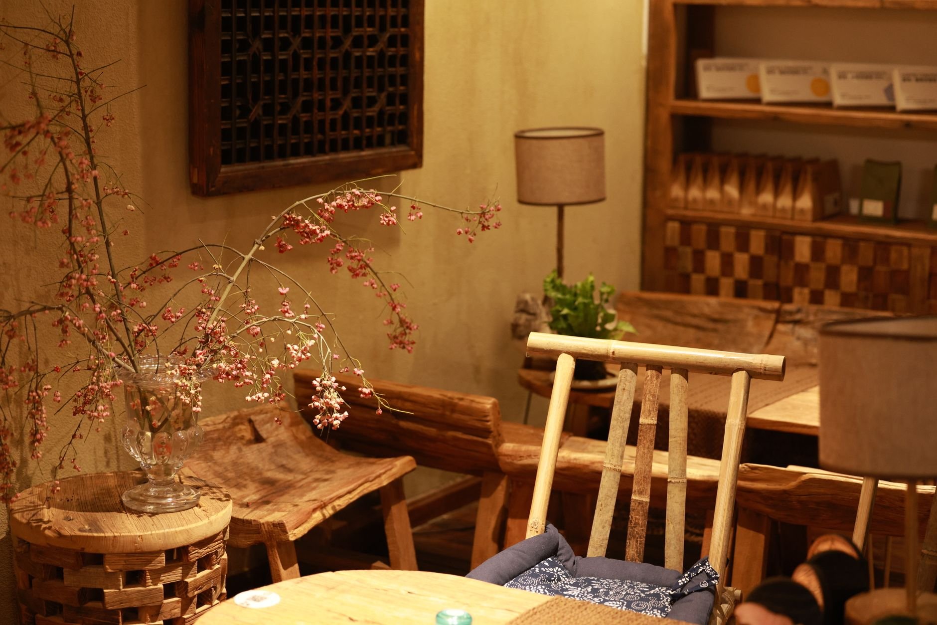 Warm and inviting rustic coffee shop interior with wooden furniture and soft lighting.